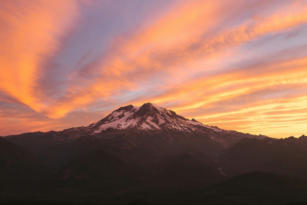 Stunning sunrise view of Mount Rainier with vibrant sky colors, Washington, USA.